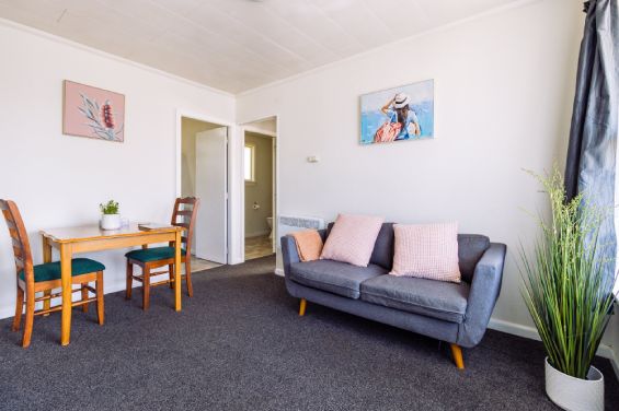 Spacious lounge and living area in the One-Bedroom Standard unit at Belle Bonne Motel Christchurch