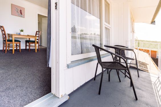 Private balcony with outdoor seating in the One-Bedroom Standard unit at Belle Bonne Motel Christchurch