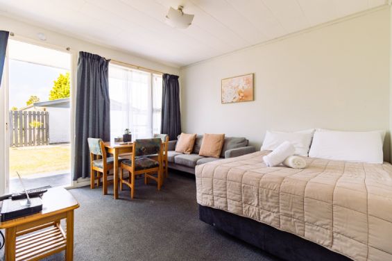 Spacious lounge and living area with garden views in the Large Suite at Belle Bonne Motel Christchurch