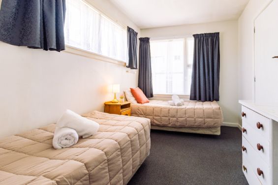 Second bedroom with twin beds, perfect for families in the Two-Bedroom Standard unit at Belle Bonne Motel Christchurch