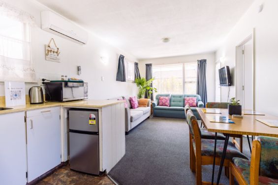 Spacious lounge area featuring garden views in the Two-Bedroom Garden unit at Belle Bonne Motel Christchurch