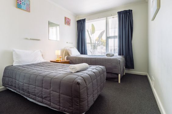 The second bedroom has two single beds in the Large Two-Bedroom Apartment at Belle Bonne Motel Christchurch